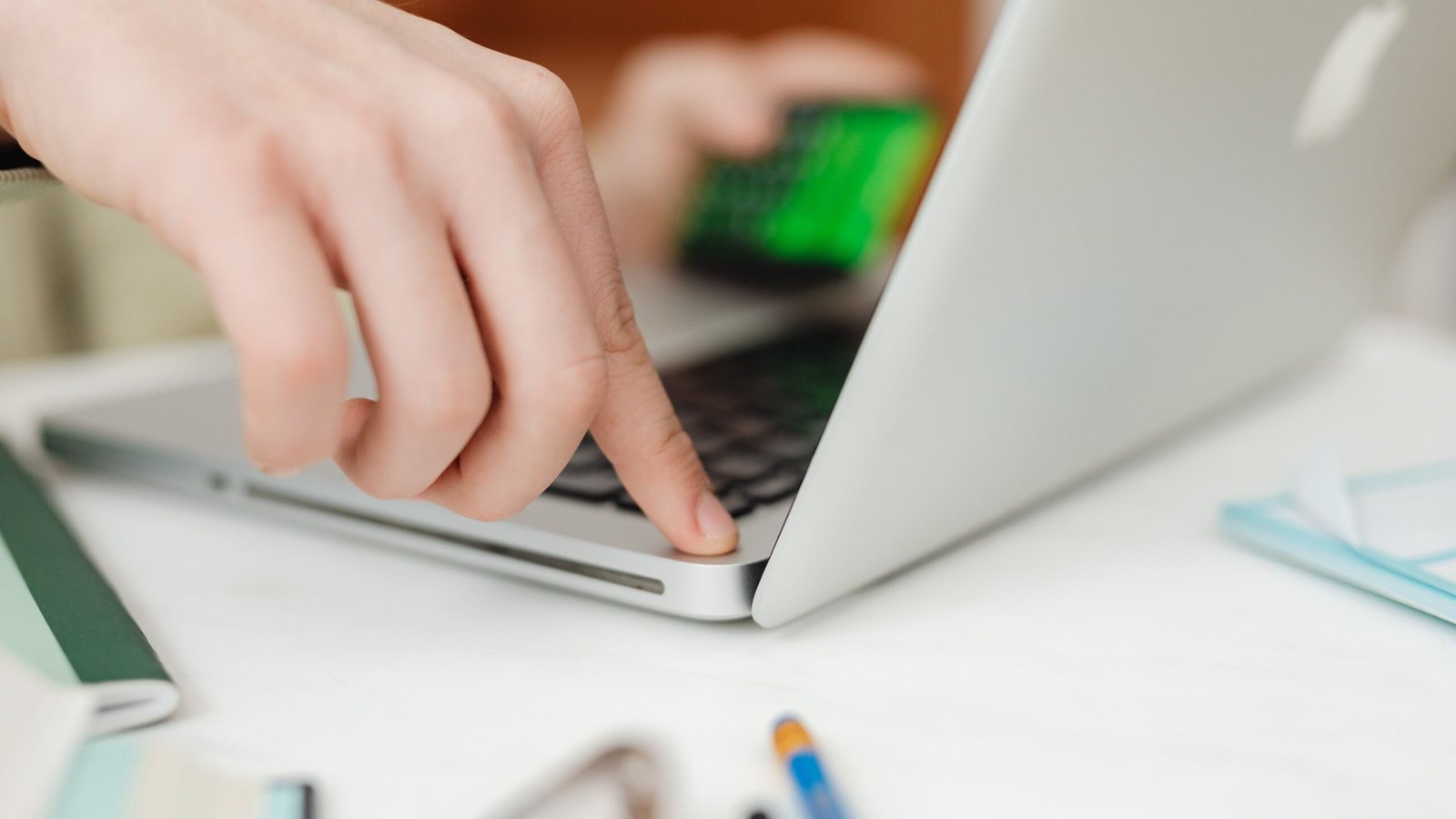 Person using a laptop at a home-office desk to plan freelance project payments