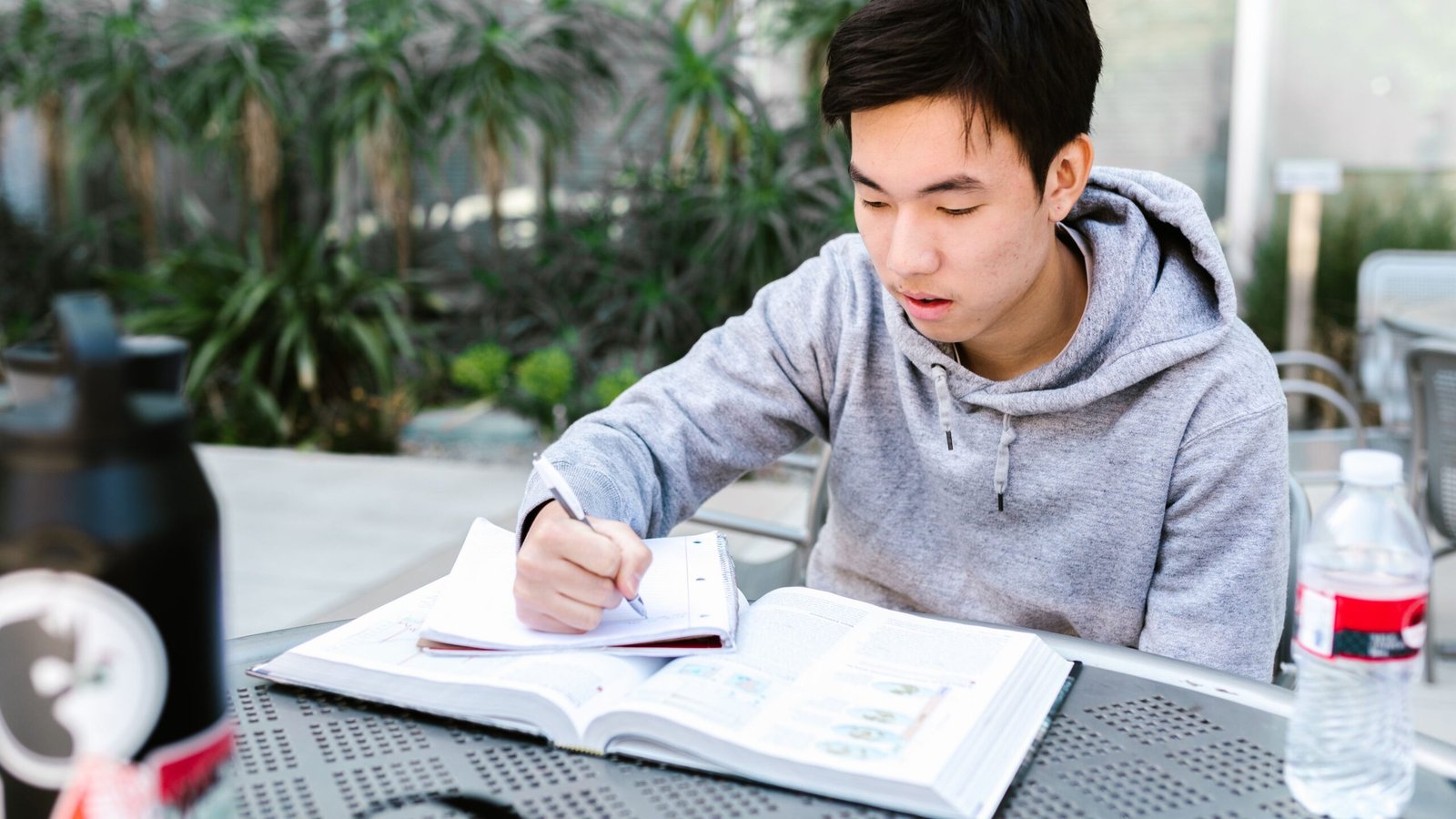University student reading academic materials while planning future loan payments
