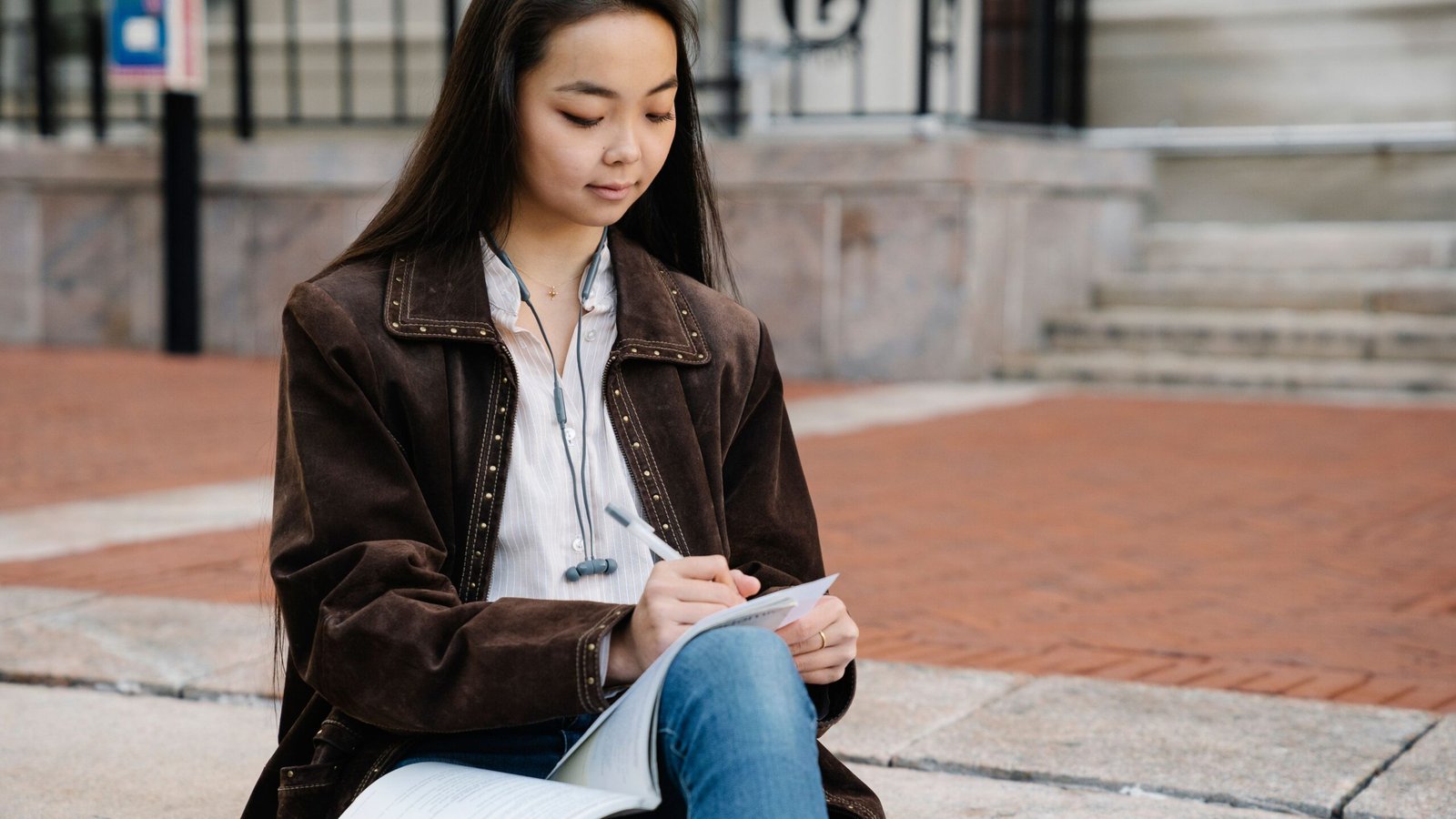 College student studying with paperwork while reviewing student loan options