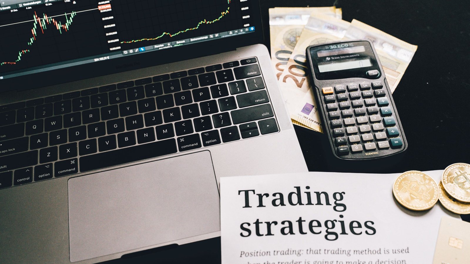 Laptop, calculator and printed investing documents on a desk for evaluating financial claims.