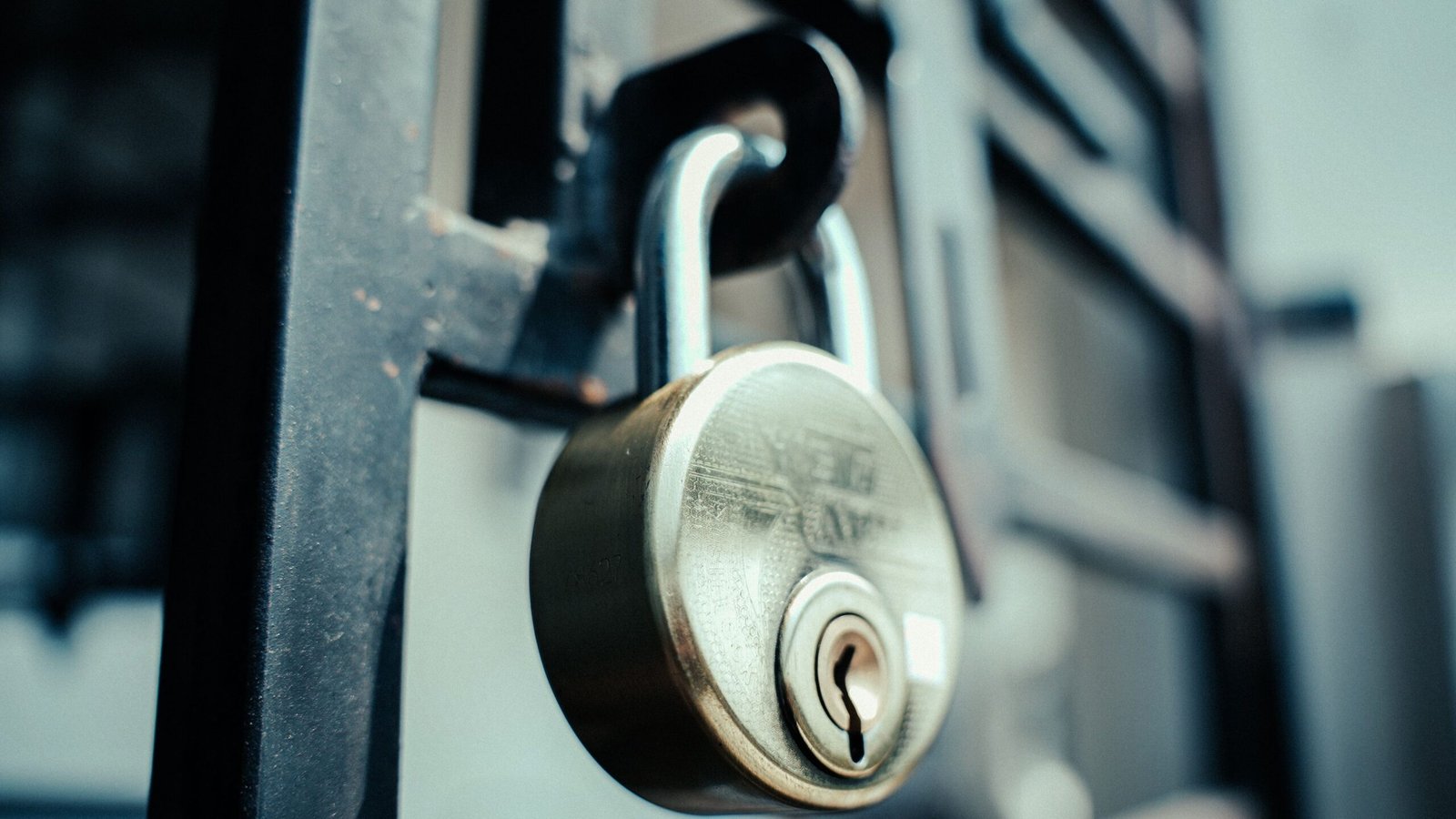 Close-up of a secured metal padlock illustrating the protection of financial identity.