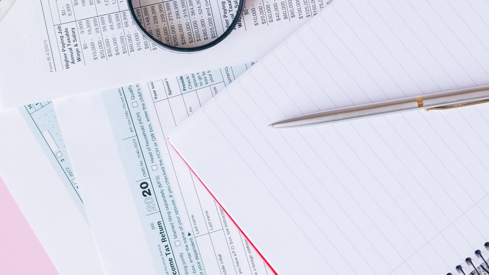 Calculator and expense records on desk for separating personal and business purchases.