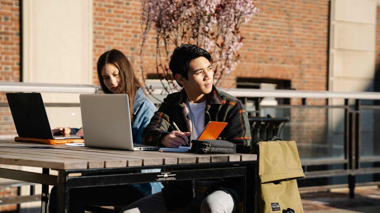 Two college students studying and reviewing information about education costs