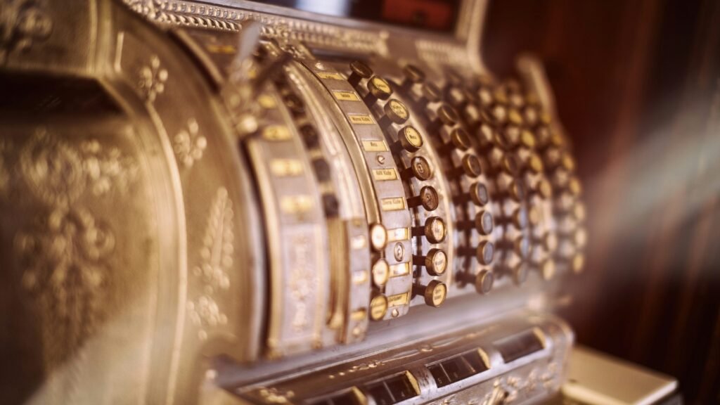 Close-up of an antique cash register with metal keys.