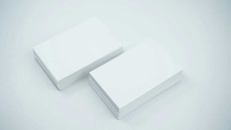 Two stacks of blank paper cards on a gray surface.