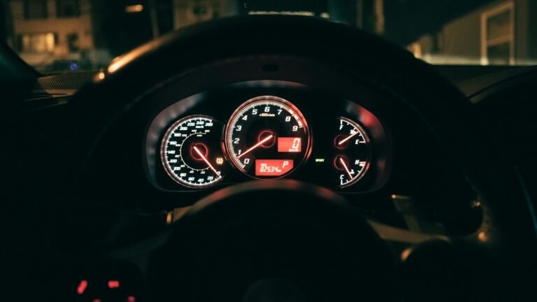 Illuminated vehicle gauges and an odometer showing kilometres.