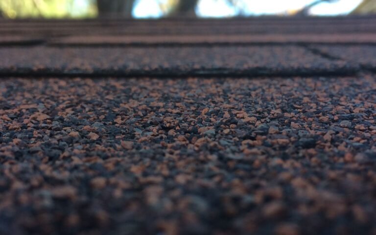 Close-up of textured roof shingles with a softly blurred background.
